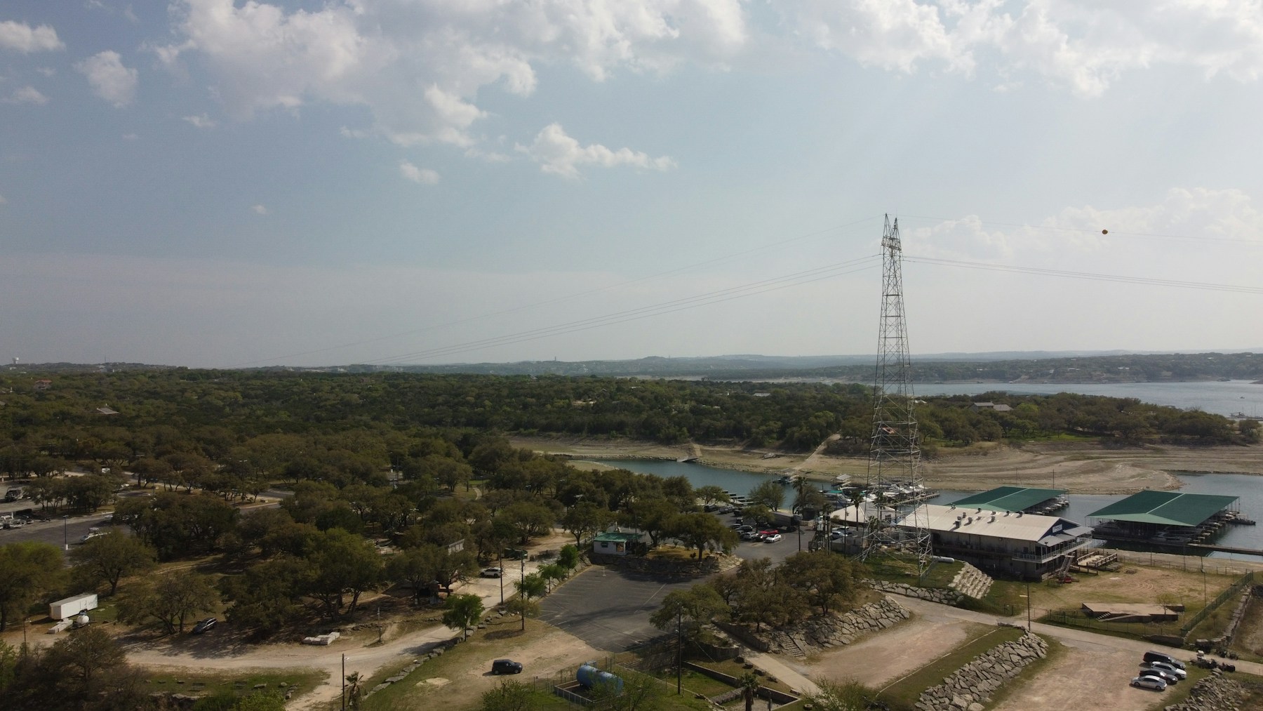 Power transmission lines crossing a lakeside infrastructure corridor