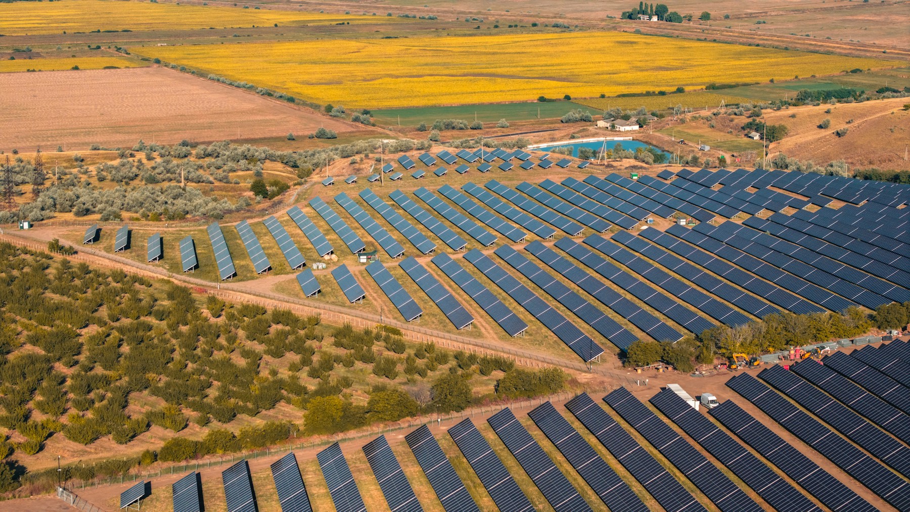 Aerial photograph of a solar farm surrounded by agricultural land